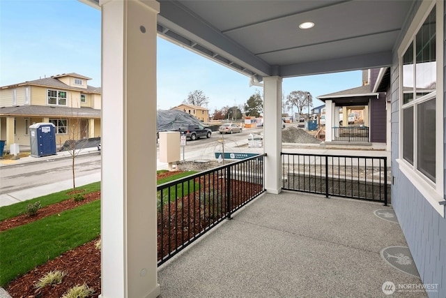 balcony featuring covered porch and a residential view