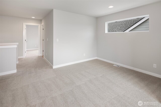 carpeted spare room with visible vents, recessed lighting, and baseboards