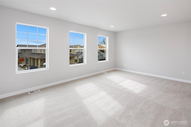 empty room featuring recessed lighting, visible vents, baseboards, and carpet floors