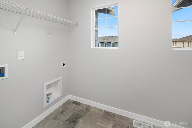 washroom with baseboards, visible vents, hookup for an electric dryer, laundry area, and washer hookup