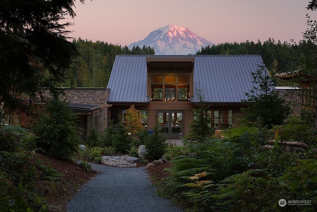 contemporary house featuring a mountain view and french doors