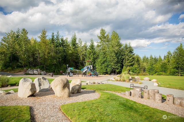 view of home's community with a playground and a yard