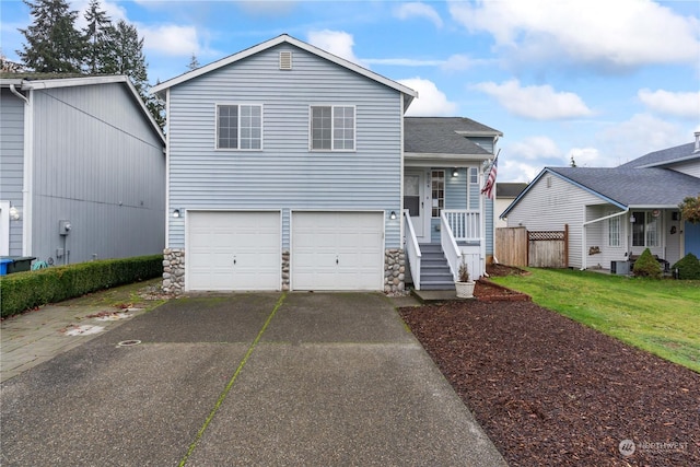 tri-level home with a front yard, a garage, and cooling unit