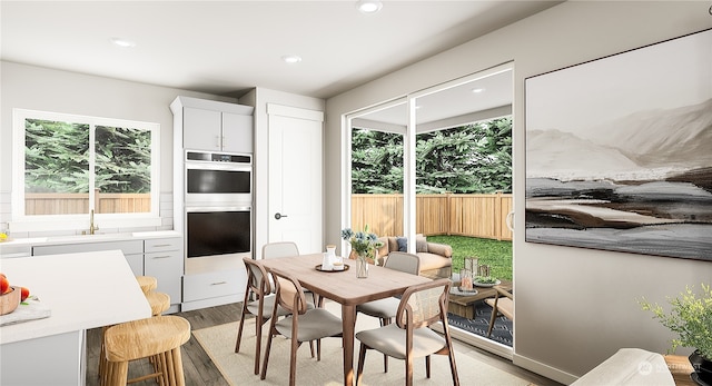 dining room featuring light hardwood / wood-style flooring and a healthy amount of sunlight