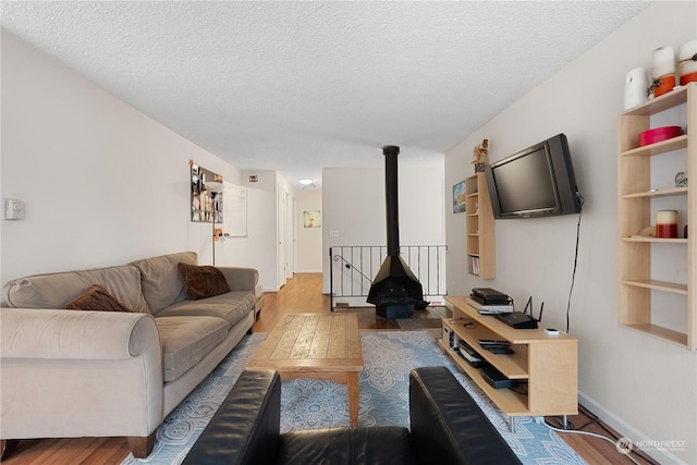 living room with hardwood / wood-style flooring and a textured ceiling