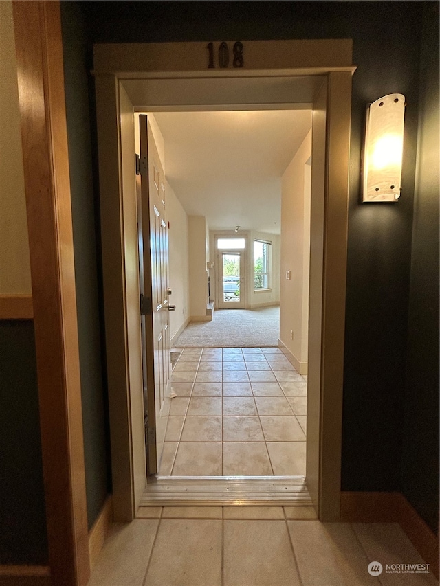 hallway featuring light tile patterned flooring