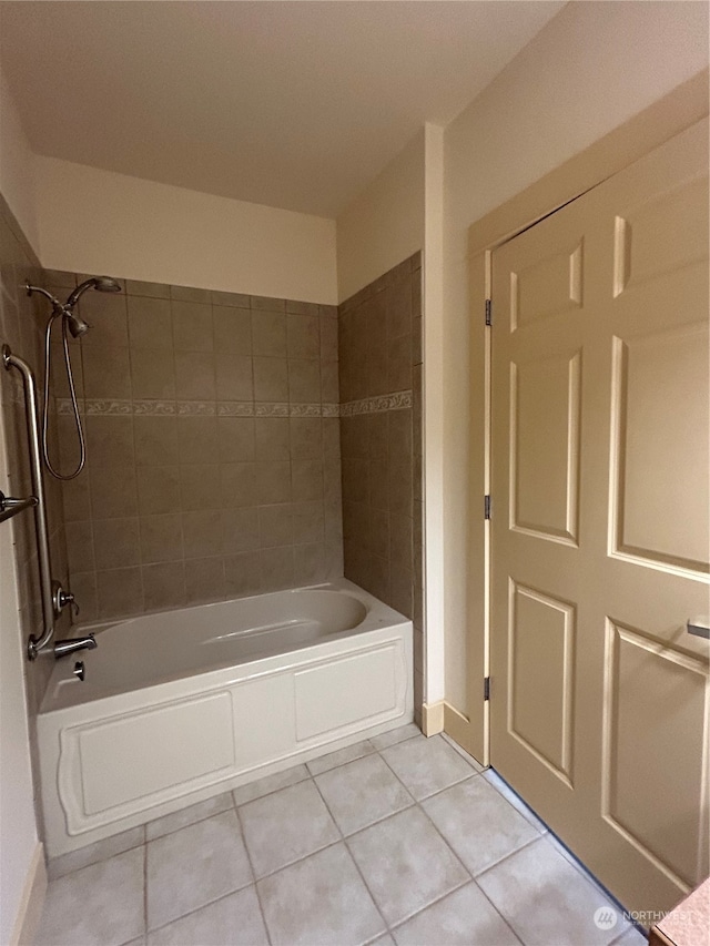 bathroom with tile patterned flooring and tiled shower / bath combo