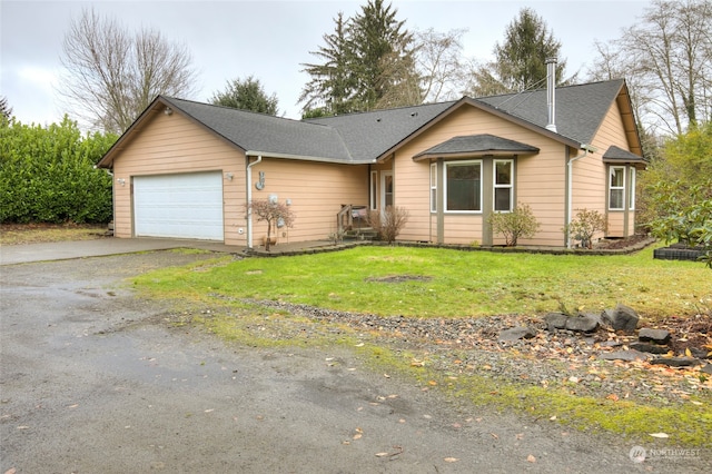 ranch-style home with a garage and a front lawn