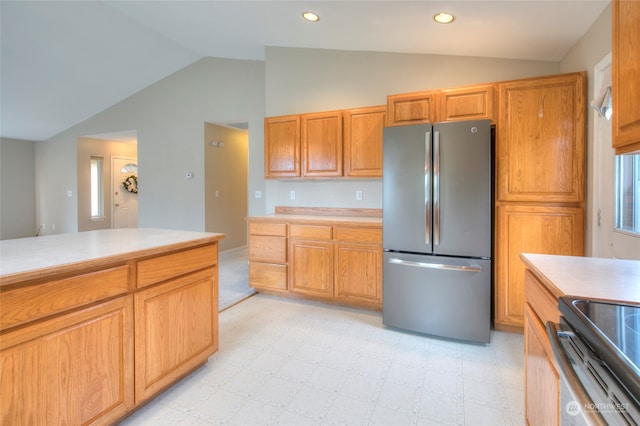 kitchen featuring stainless steel appliances and vaulted ceiling