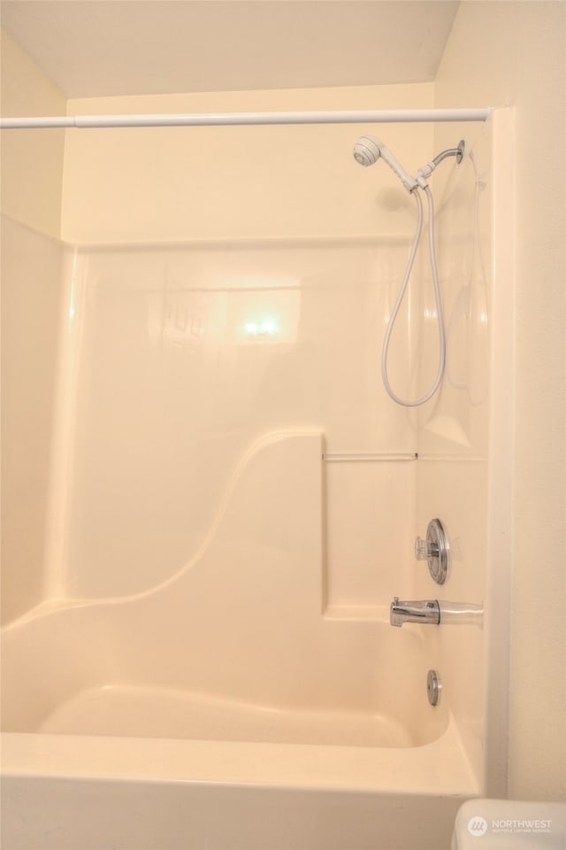 bathroom with bathing tub / shower combination