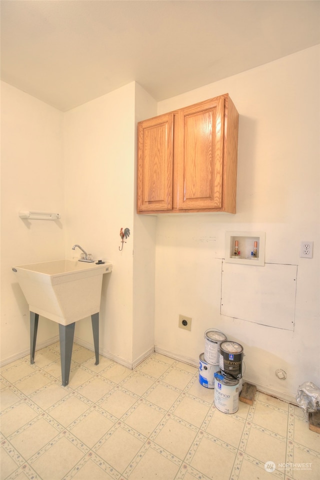 laundry room with sink, hookup for a washing machine, cabinets, and hookup for an electric dryer