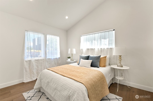 bedroom with hardwood / wood-style flooring and lofted ceiling