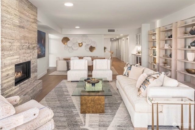 living room featuring a fireplace and dark wood-type flooring