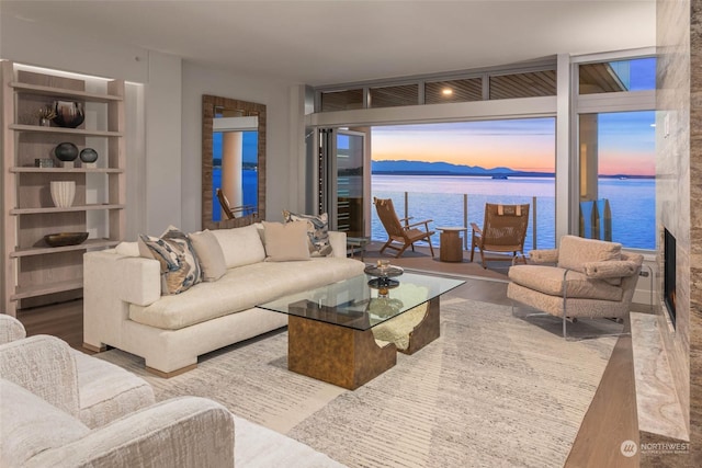 1250 Alki Ave SW Phg, Phg, Seattle, WA 98116 - living room featuring a water view, wood finished floors, and a wall of windows