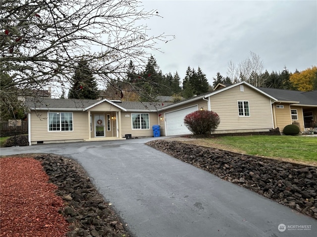 ranch-style home featuring a front lawn and a garage