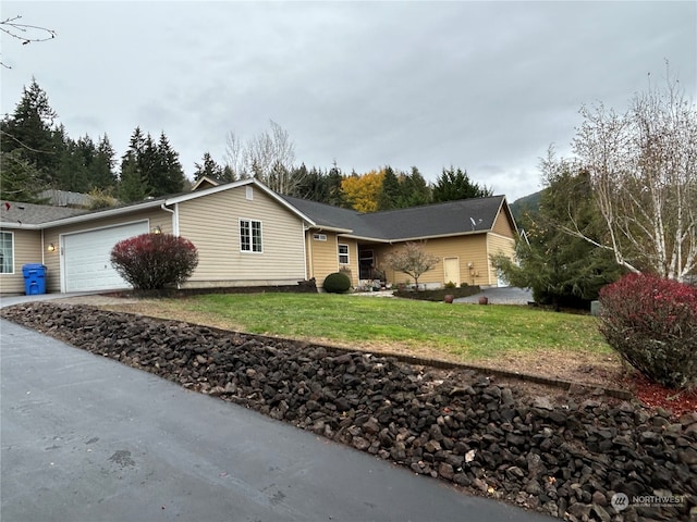 single story home featuring a front lawn and a garage