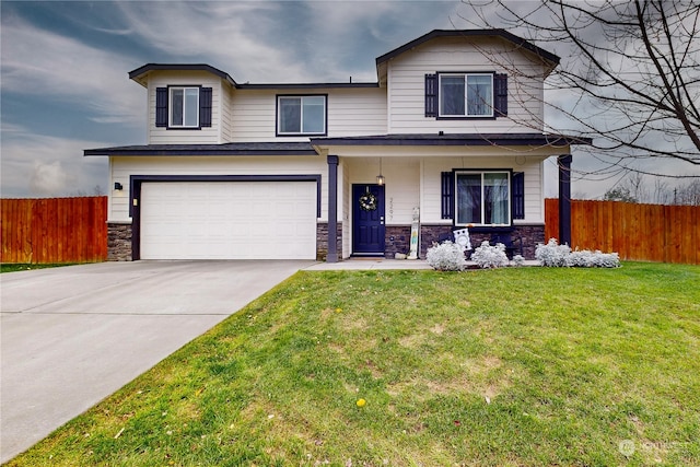 view of front property featuring a front yard and a garage