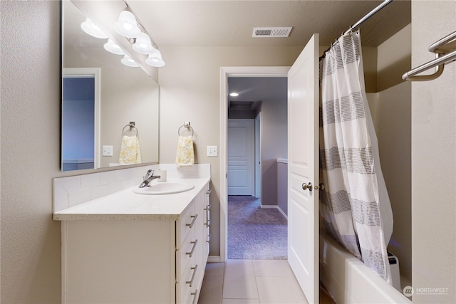 bathroom with tile patterned floors, shower / tub combo with curtain, and vanity