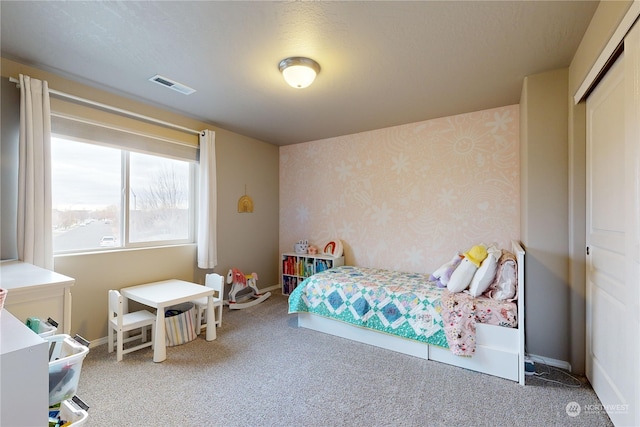 bedroom featuring carpet and a closet