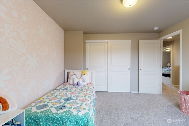 carpeted bedroom featuring a closet