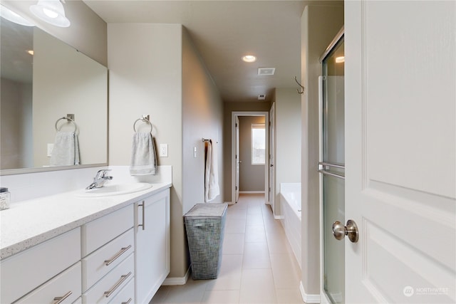 bathroom featuring vanity, tile patterned flooring, and a bathtub