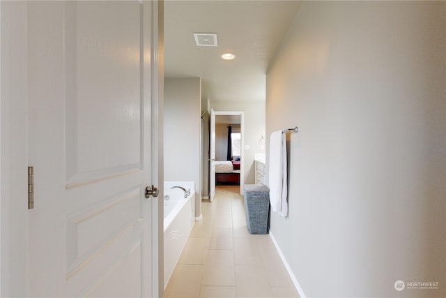 hallway featuring light tile patterned flooring