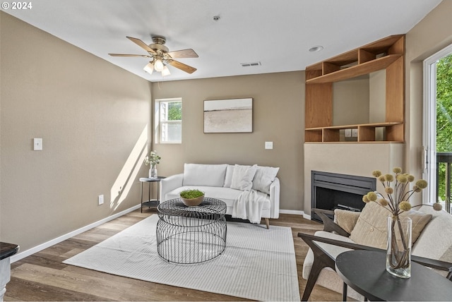 living room featuring ceiling fan and hardwood / wood-style flooring