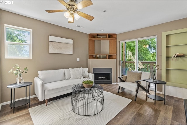 living room featuring hardwood / wood-style flooring, ceiling fan, and a wealth of natural light