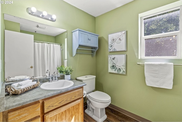 bathroom with vanity, hardwood / wood-style flooring, and toilet