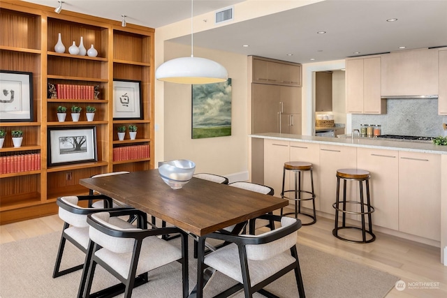 dining area with light hardwood / wood-style flooring