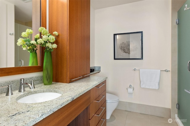 bathroom featuring toilet, vanity, and tile patterned floors