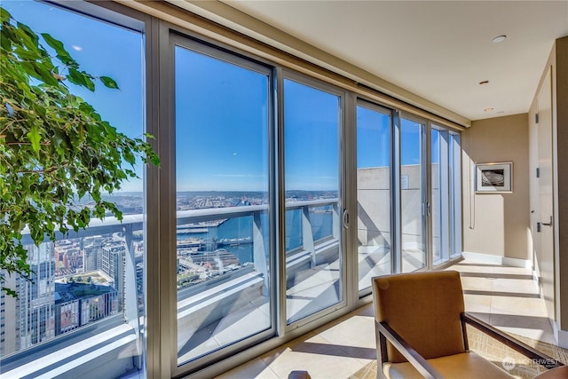 interior space featuring a water view and light tile patterned floors