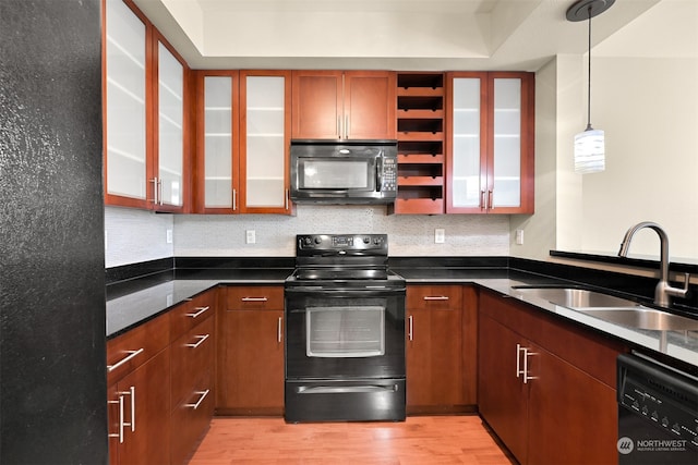 kitchen with decorative backsplash, sink, black appliances, light hardwood / wood-style flooring, and hanging light fixtures