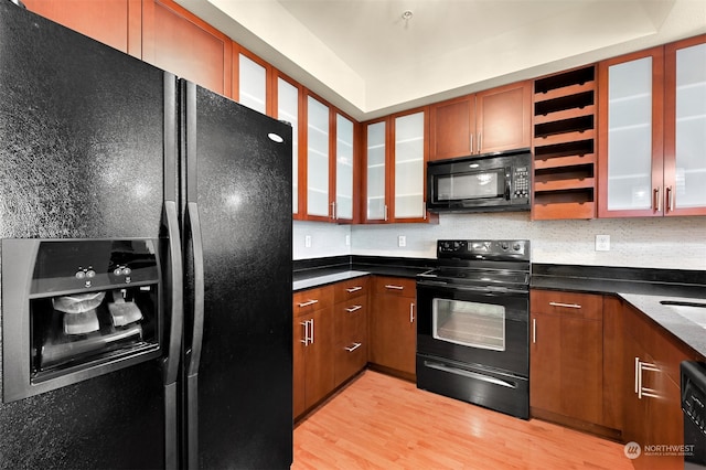 kitchen with black appliances and light hardwood / wood-style flooring