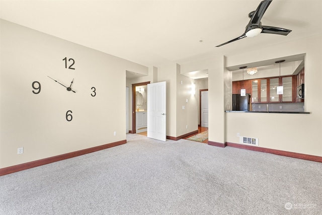 unfurnished living room with carpet flooring and ceiling fan