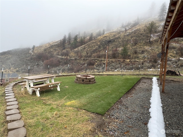 view of yard with a fire pit and a mountain view