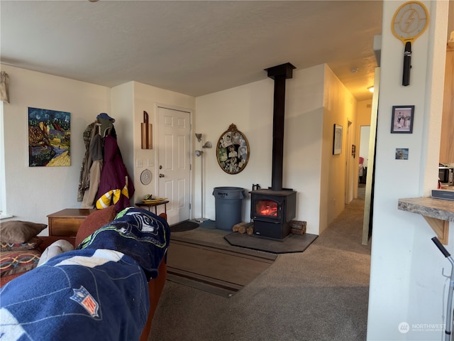 carpeted living room featuring a wood stove