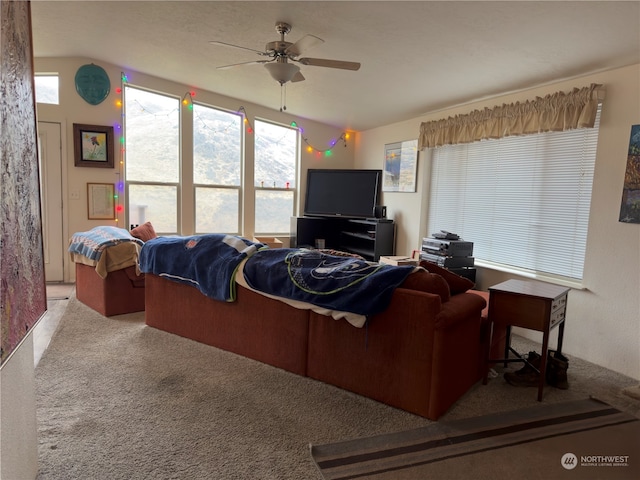 carpeted living room with ceiling fan