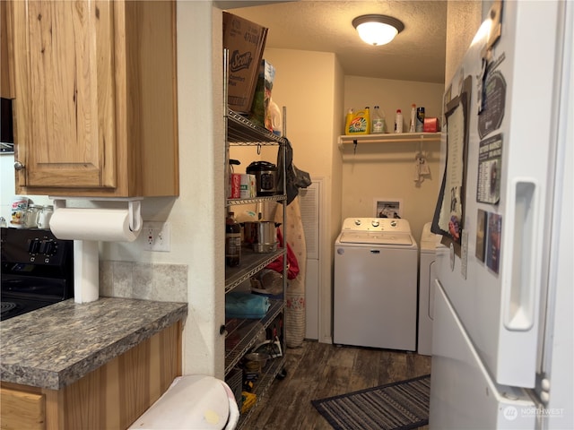 laundry area with dark hardwood / wood-style flooring, washer and dryer, and a textured ceiling