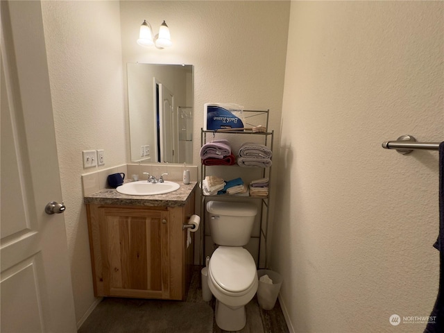 284 Blue Lake Rd, Oroville, WA 98844 - bathroom with vanity, toilet, and a textured wall