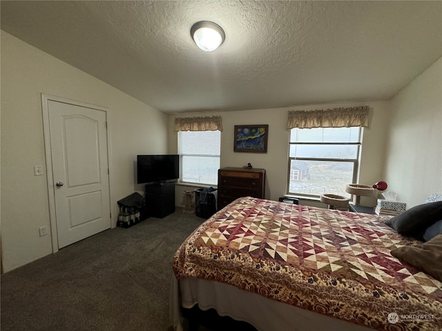 carpeted bedroom featuring a textured ceiling and lofted ceiling