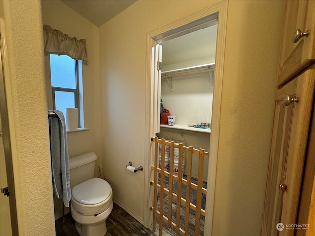 bathroom with toilet and hardwood / wood-style flooring