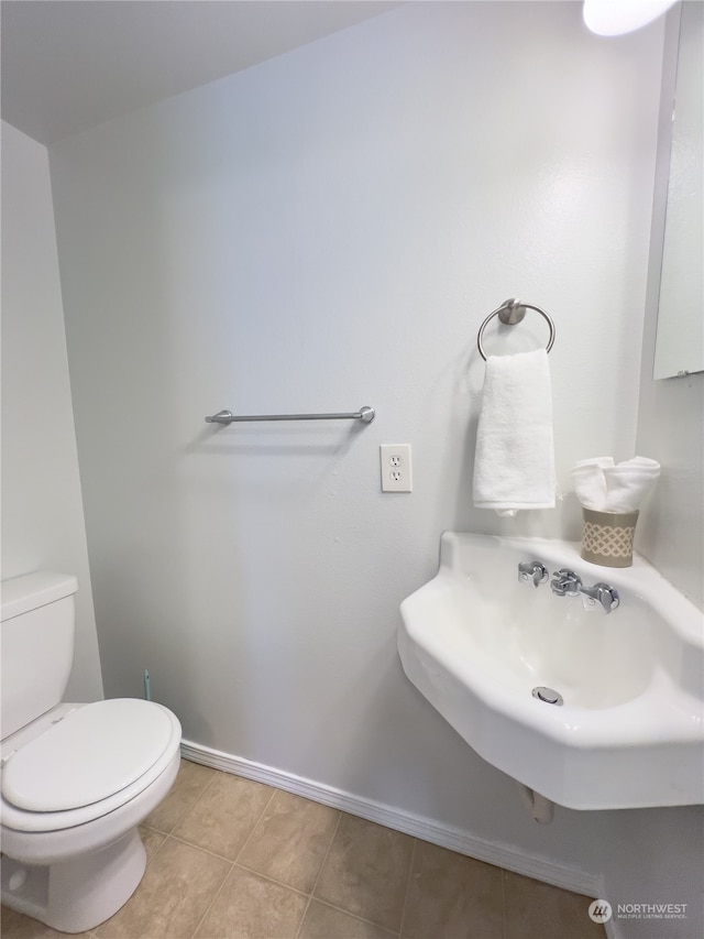 bathroom with tile patterned flooring, toilet, and sink