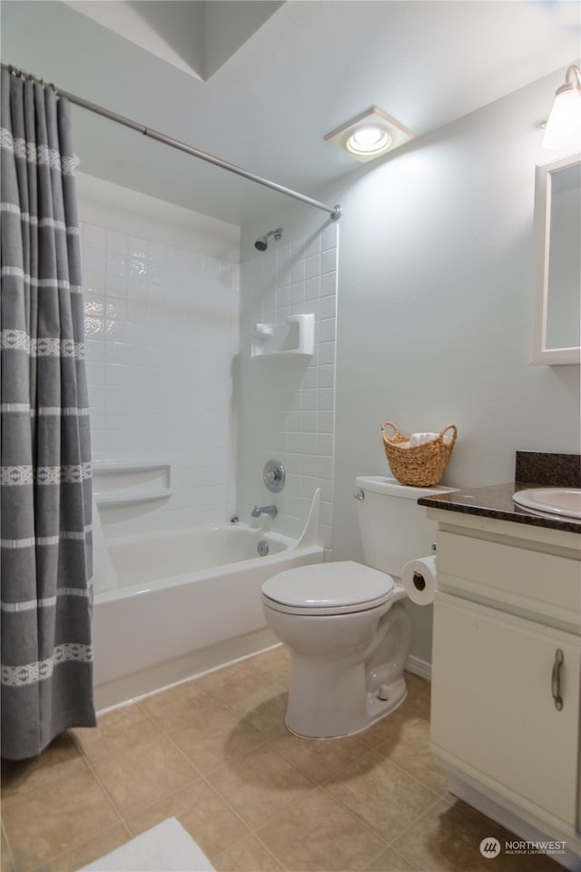 full bathroom featuring tile patterned floors, vanity, toilet, and shower / tub combo