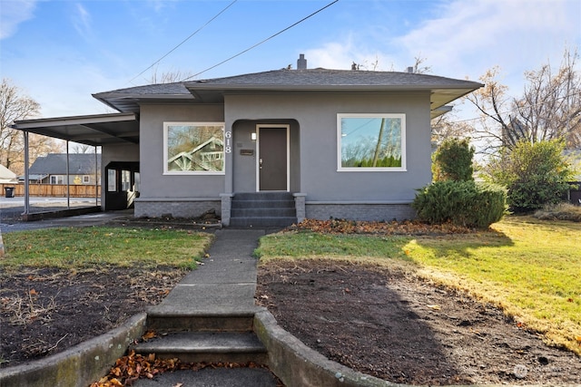 bungalow featuring a front yard and a carport