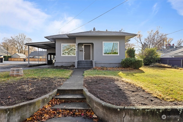 bungalow-style home featuring a front lawn and a carport