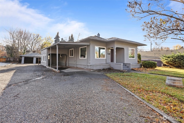 view of front of property with a carport and a front yard