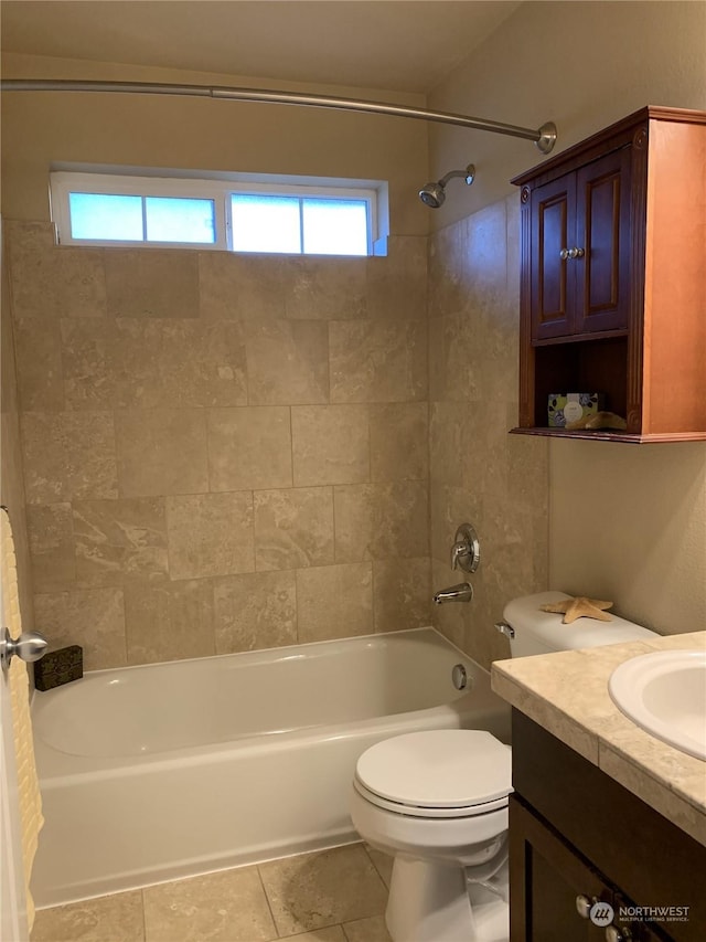 full bathroom featuring tile patterned floors, vanity, toilet, and tiled shower / bath