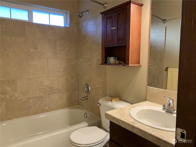 full bathroom with vanity, toilet, and tiled shower / bath