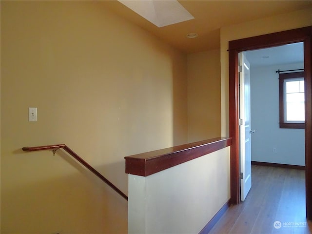 corridor with hardwood / wood-style floors